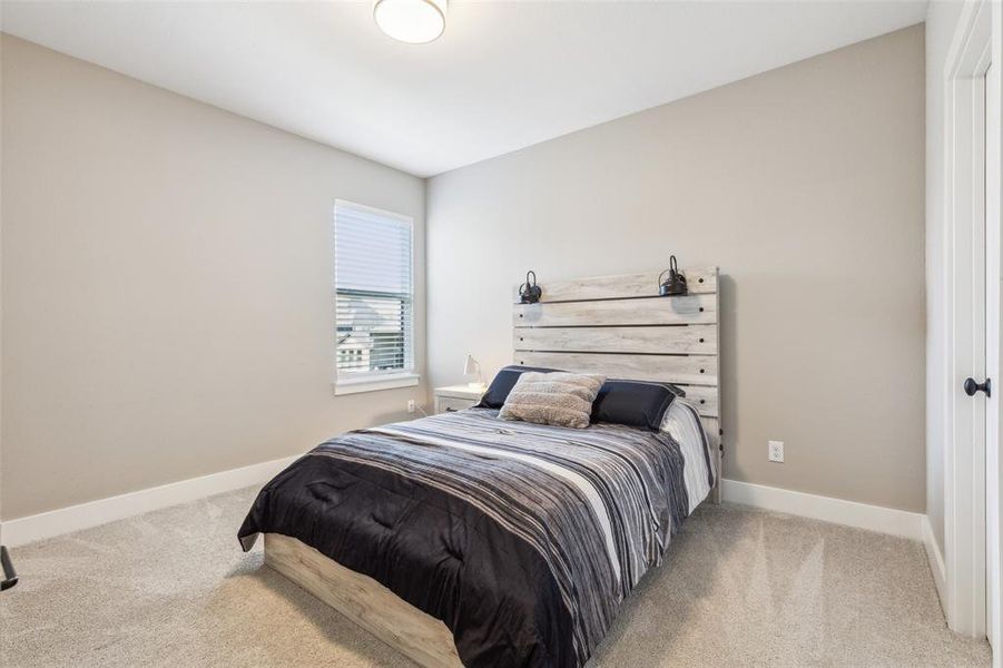 Bedroom featuring light colored carpet