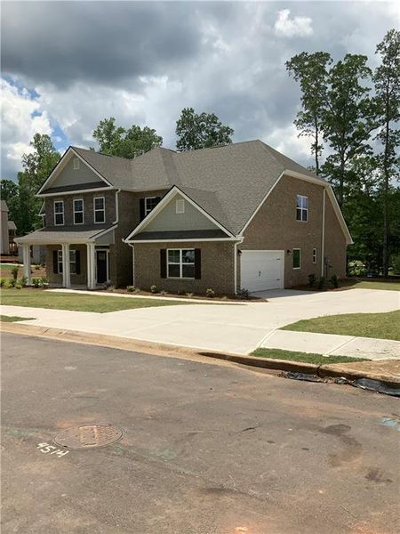 Front exterior of a new home in Mirror Lake at South Harbour, Villa Rica, GA, highlighting curb appeal (Image 22).