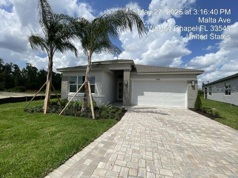 Front exterior of a new home in Valencia Ridge, Wesley Chapel, FL, highlighting curb appeal (Image 16).
