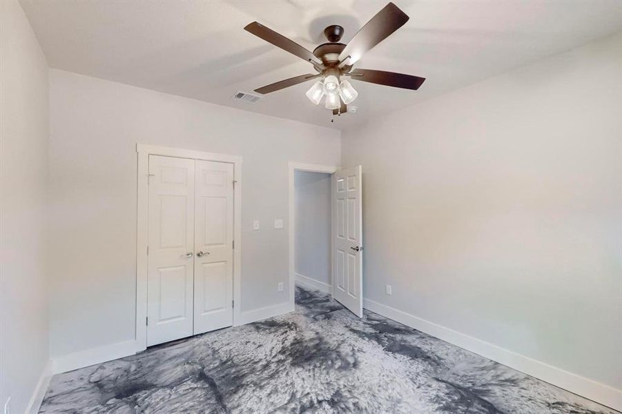 Unfurnished bedroom with a closet and ceiling fan