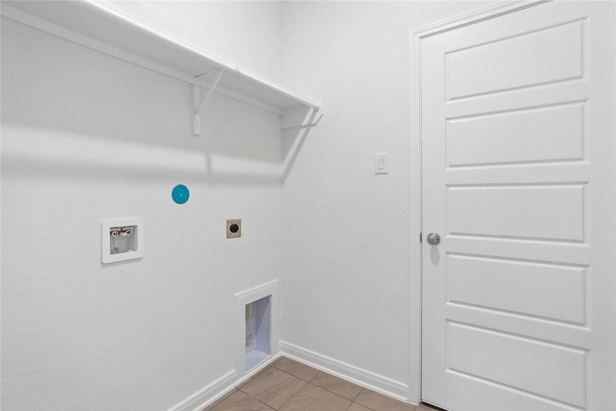 The laundry room features a streamlined shelf to keep all your essentials neatly within reach.