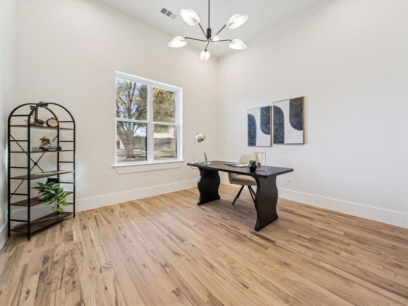 Office featuring a notable chandelier and light wood-type flooring