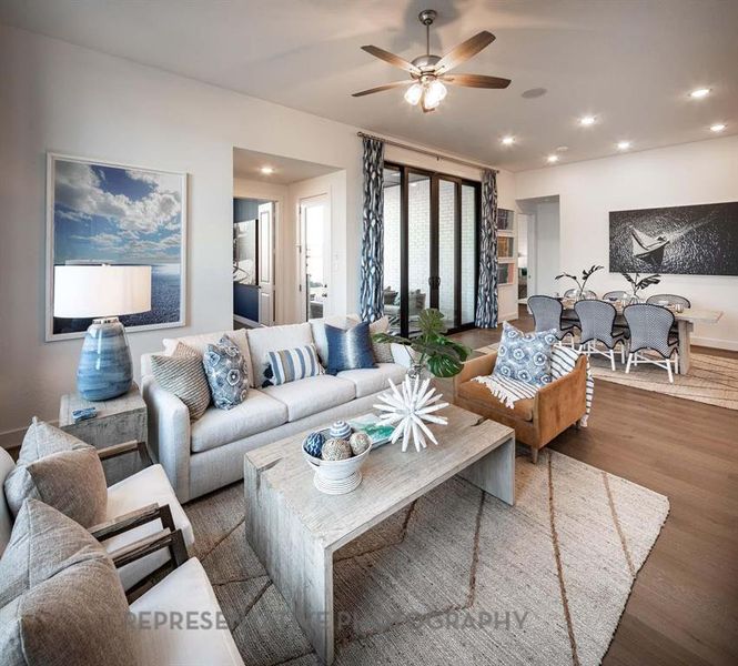 Living area featuring wood finished floors, recessed lighting, and a ceiling fan Living area featuring wood finished floors, recessed lighting, and a ceiling fan