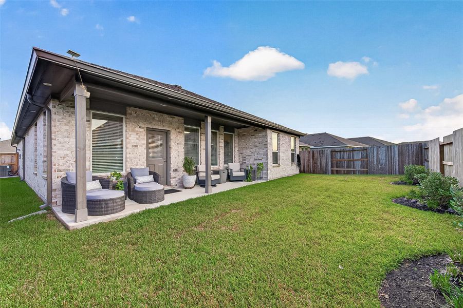 Spacious fenced backyard with covered patio and plenty of lawn space. Spacious fenced backyard with covered patio and plenty of lawn space.