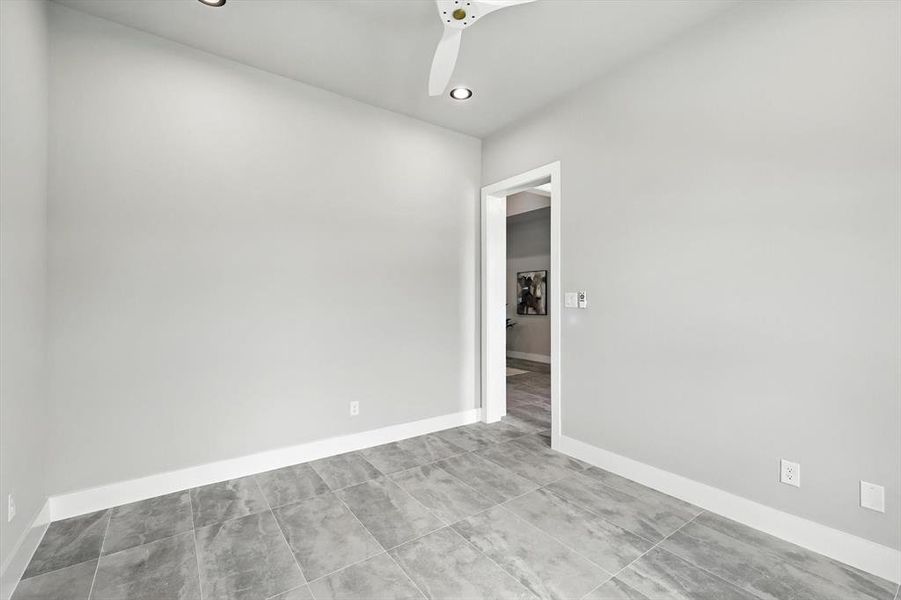 Empty room featuring recessed lighting, a ceiling fan, and tile patterned flooring