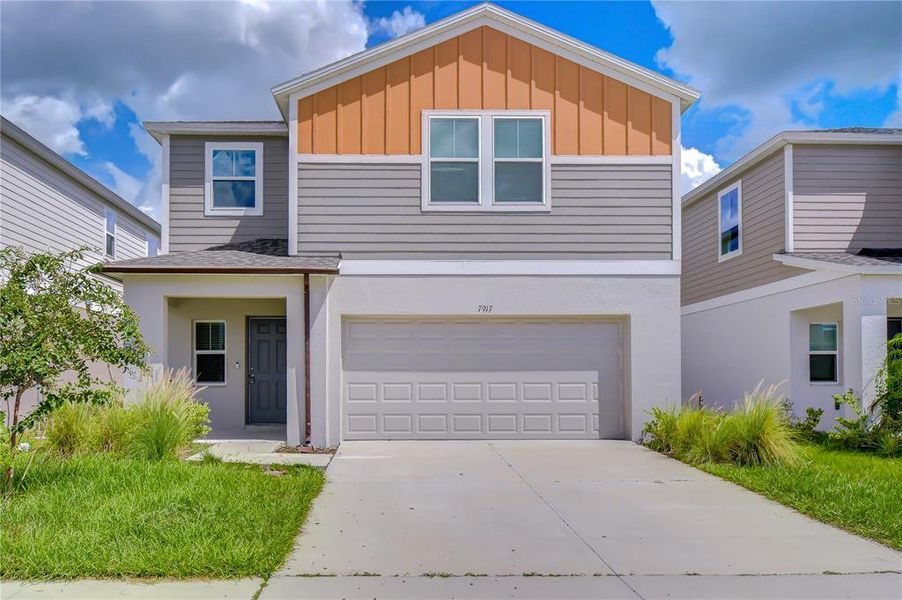 Front exterior of a new home in Pasadena Point, Wesley Chapel, FL, highlighting curb appeal (Image 23).