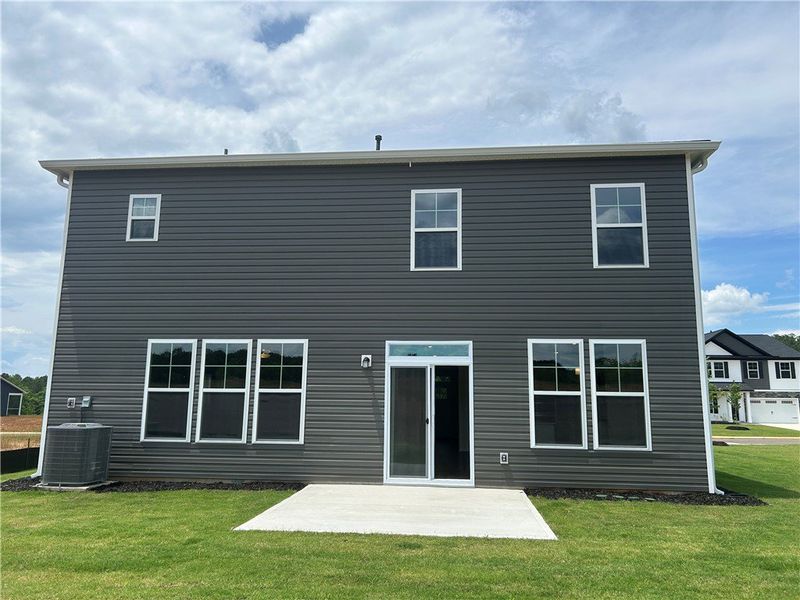 A newly constructed home features dark gray siding