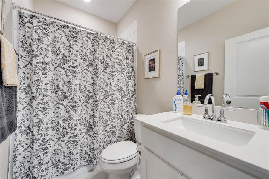 Bathroom with vanity and a shower with shower curtain