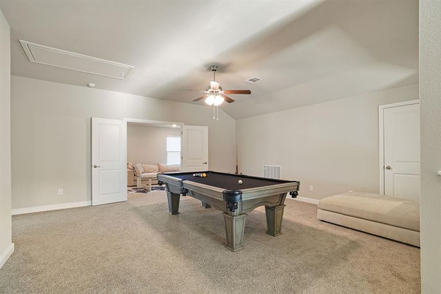 Playroom featuring pool table, carpet flooring, a ceiling fan, and lofted ceiling Playroom featuring pool table, carpet flooring, a ceiling fan, and lofted ceiling
