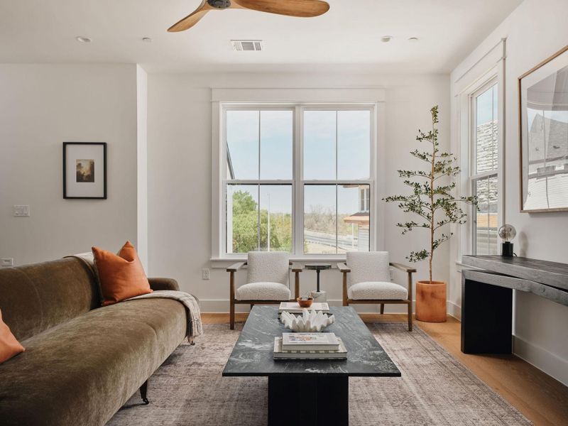 Living area with ceiling fan, light wood-style flooring, and recessed lighting