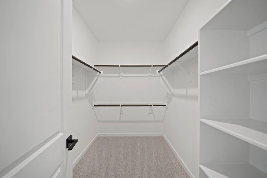Walk-in closet in the primary suite (*Photo not of actual home and used for illustration purposes only.) Walk-in closet in the primary suite (*Photo not of actual home and used for illustration purposes only.)
