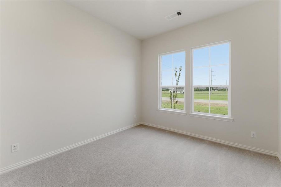 Room with neutral wall color, light gray carpeting, and white baseboards