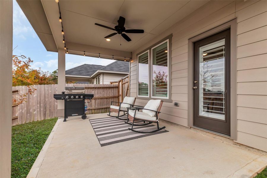Cozy covered patio area with a ceiling fan, outdoor seating, and room for your grill. Perfect view of the Sunset. Cozy covered patio area with a ceiling fan, outdoor seating, and room for your grill. Perfect view of the Sunset.