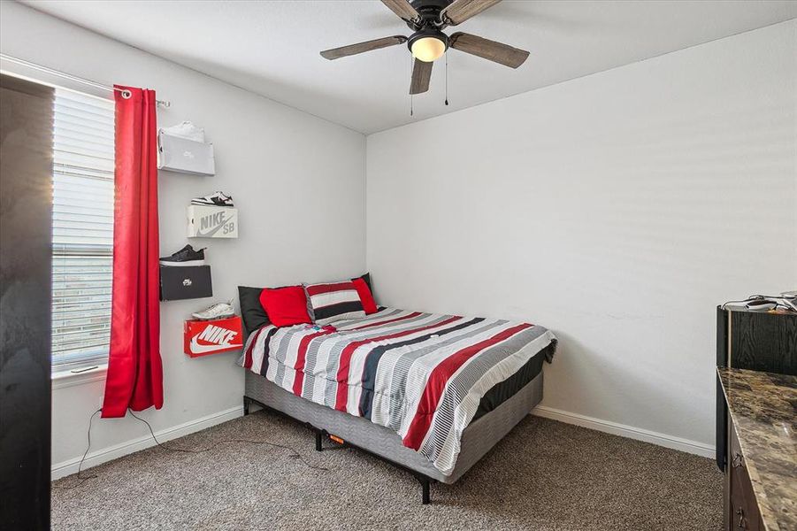 Bedroom with ceiling fan and carpet floors Bedroom with ceiling fan and carpet floors