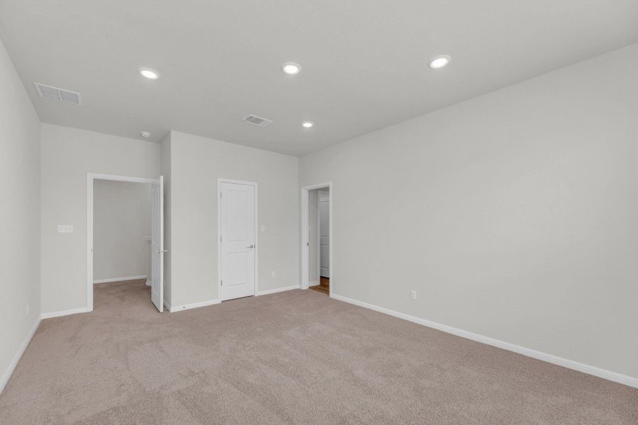 Unfurnished bedroom featuring light colored carpet and recessed lighting