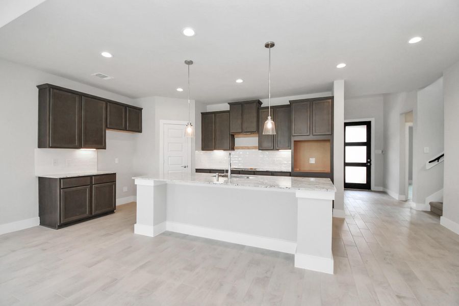Take in another perspective of this impressive open and bright kitchen. Sample photo of completed home with similar floor plan. Actual colors and selections may vary. Take in another perspective of this impressive open and bright kitchen. Sample photo of completed home with similar floor plan. Actual colors and selections may vary.