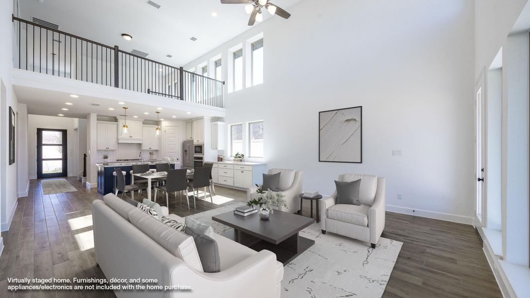 Living area featuring dark wood finished floors, a high ceiling, ceiling fan, and recessed lighting
