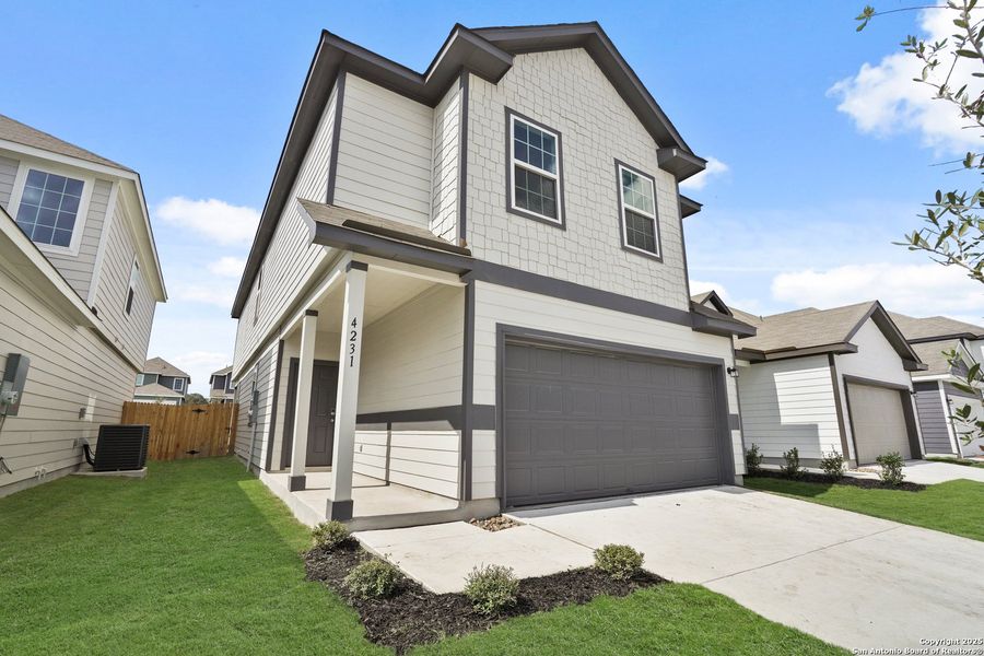 Front exterior of a new home in Melissa Ranch, San Antonio, TX, highlighting curb appeal (Image 2).