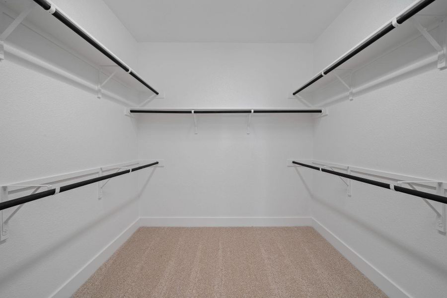 Walk-in closet in Primary Bedroom Walk-in closet in Primary Bedroom