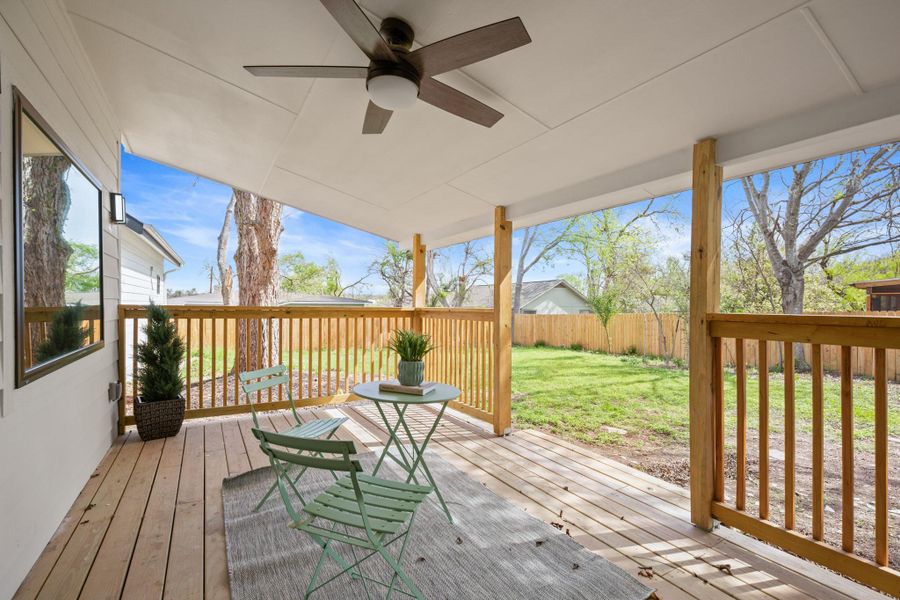 Deck with a fenced backyard and a ceiling fan