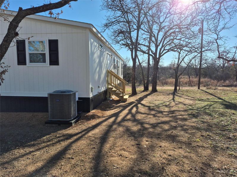 View of side of property featuring a central air condition unit