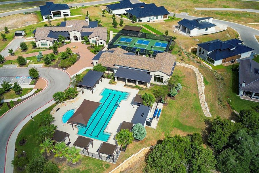 An aerial perspective showcases a sprawling neighborhood amenity center featuring a multi-lane lap pool. An aerial perspective showcases a sprawling neighborhood amenity center featuring a multi-lane lap pool.