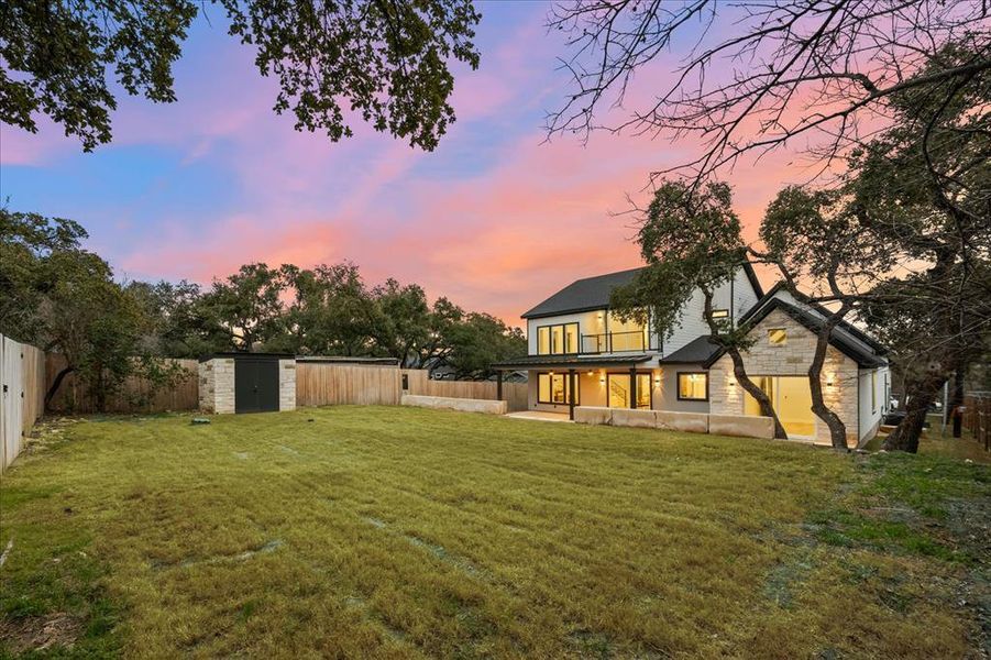 Back of property at dusk featuring stone siding Back of property at dusk featuring stone siding