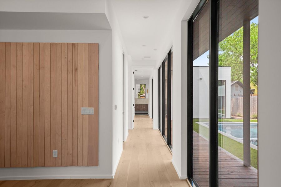 Corridor with light wood finished floors and baseboards