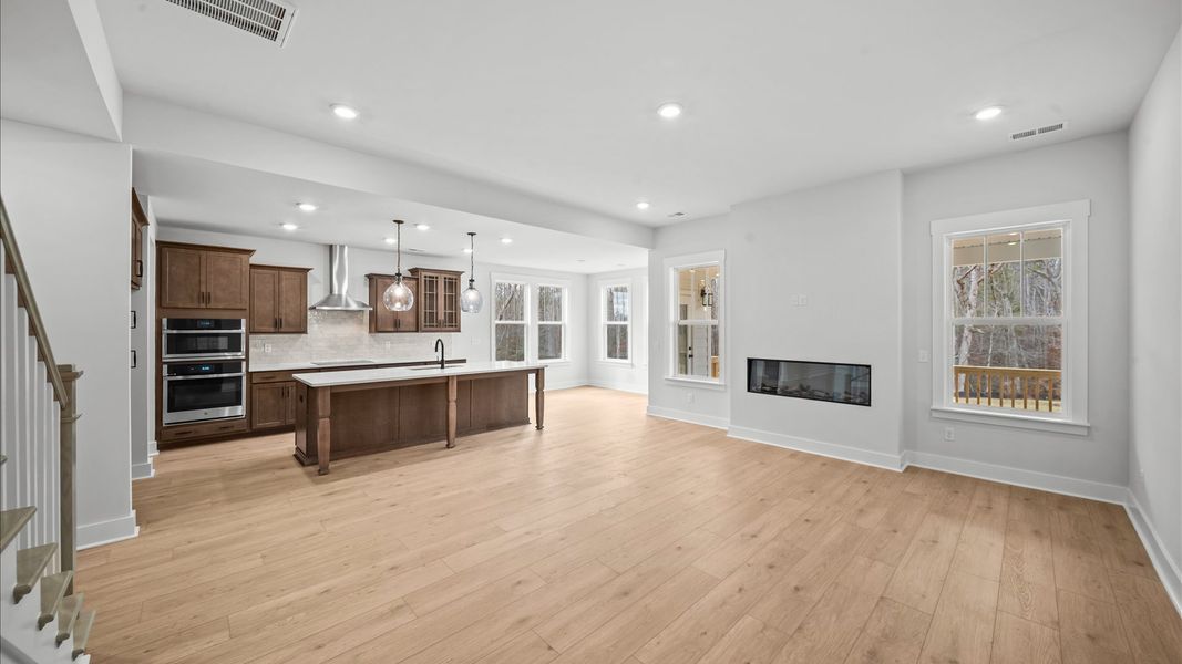 Exceptional family room featuring fireplace, tasteful finishes, and vibrant natural light