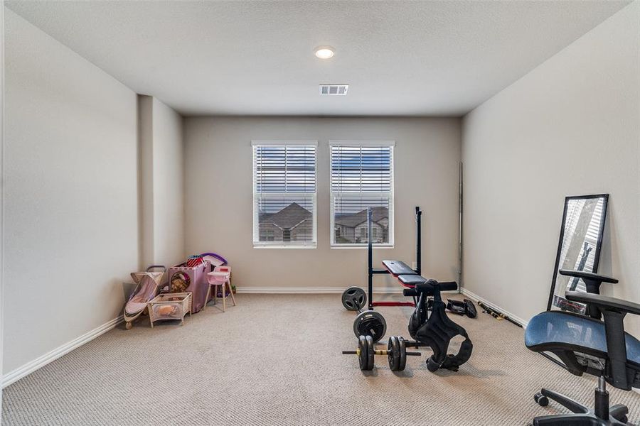 Workout area with carpet and baseboards Workout area with carpet and baseboards