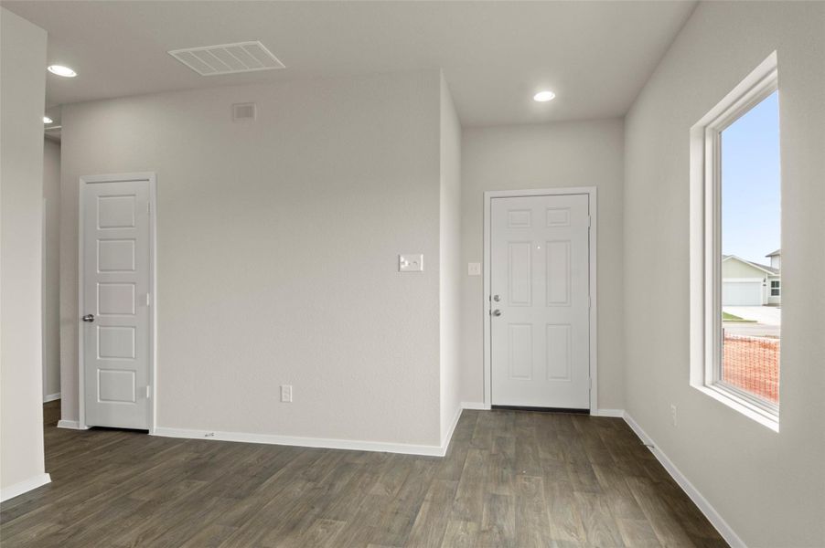 Unfurnished room with dark wood finished floors and recessed lighting
