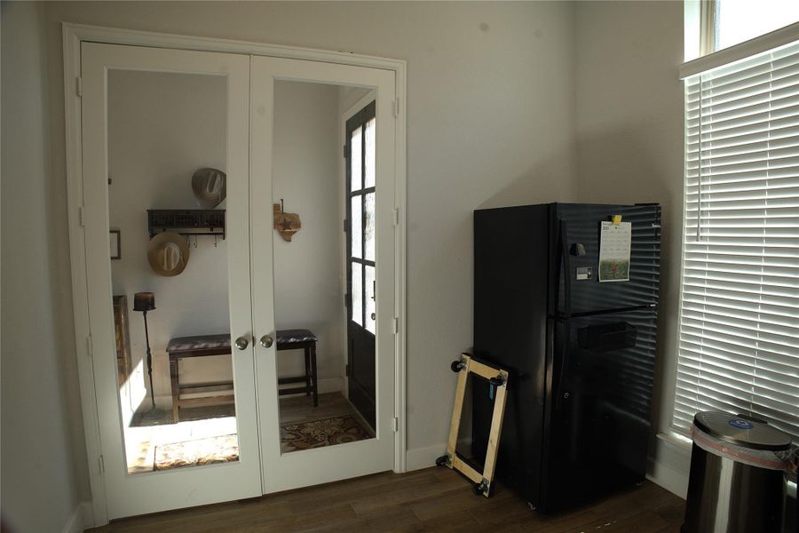 Entryway featuring french doors and wood finished floors Entryway featuring french doors and wood finished floors