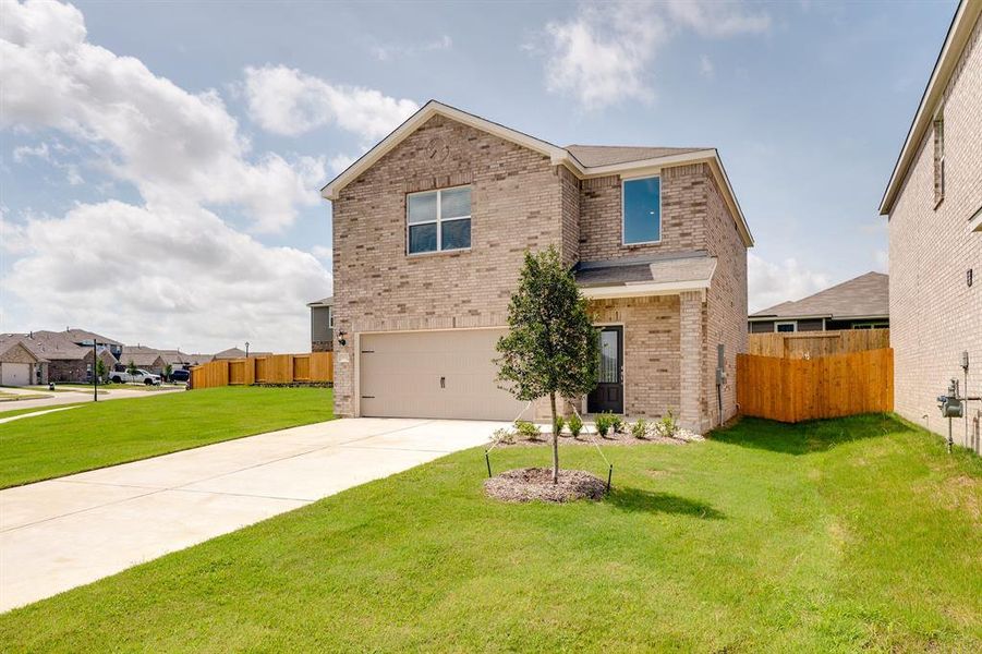 Front exterior of a new home in Patriot Estates, Venus, TX, highlighting curb appeal (Image 17).