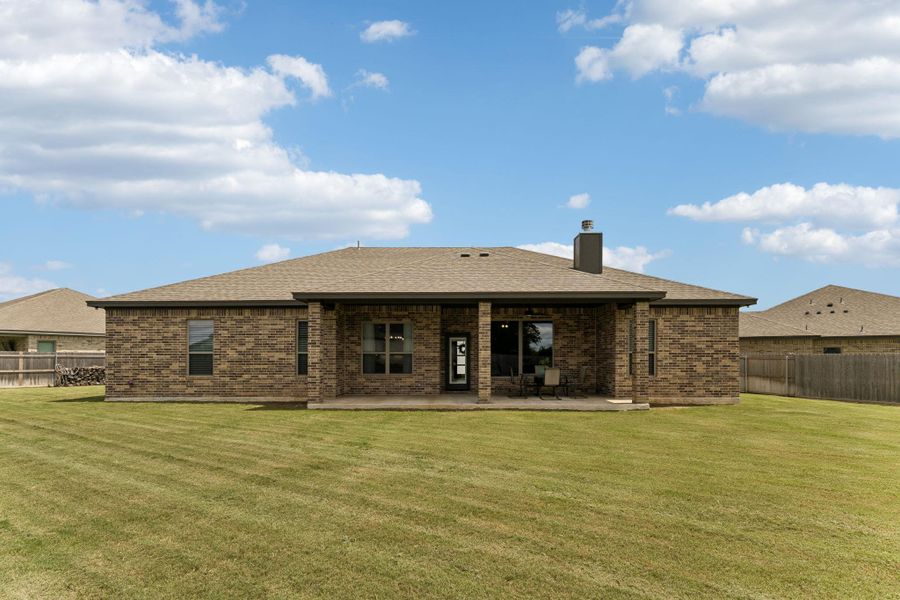 With generous green space and a substantial covered patio, the backyard offers the freedom to enjoy the outdoors without feeling crowded by neighboring homes.