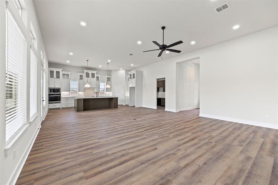 Unfurnished living room with recessed lighting, dark wood-style flooring, and ceiling fan Unfurnished living room with recessed lighting, dark wood-style flooring, and ceiling fan