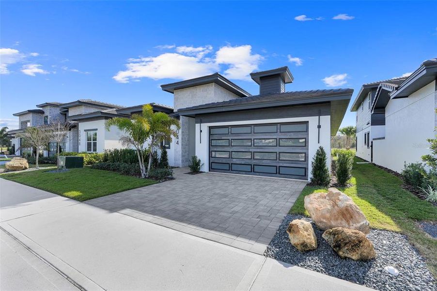 Front exterior of a new home in Hampton Green at Providence, Davenport, FL, highlighting curb appeal (Image 22).