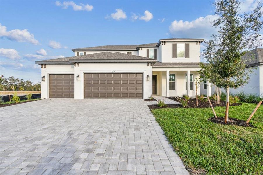 Front exterior of a new home in Creeks Edge at Twin Rivers, Parrish, FL, highlighting curb appeal (Image 1).