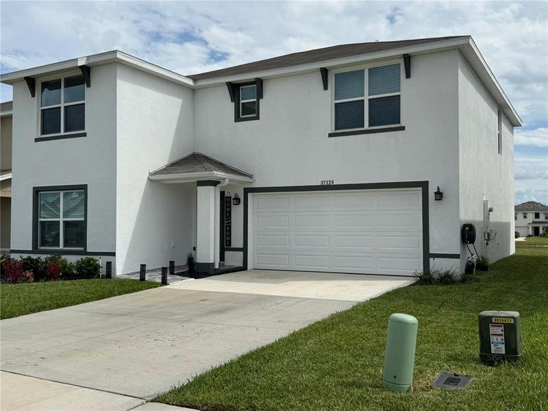 Front exterior of a new home in Zephyr Ridge, Zephyrhills, FL, highlighting curb appeal (Image 21).