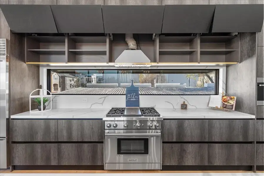 The high-end kitchen features motorized cabinets and shelving with oversized cabinetry designed for both beauty and function. The high-end kitchen features motorized cabinets and shelving with oversized cabinetry designed for both beauty and function.