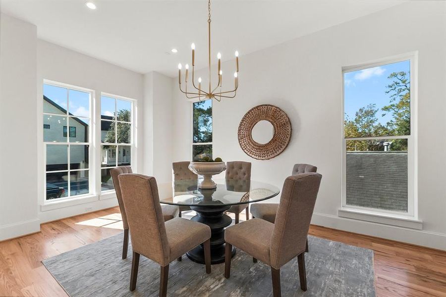 Stunning formal dining area featuring oversized windows, a modern chandelier, and an inviting atmosphere for gatherings