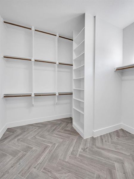 Spacious closet featuring light parquet floors