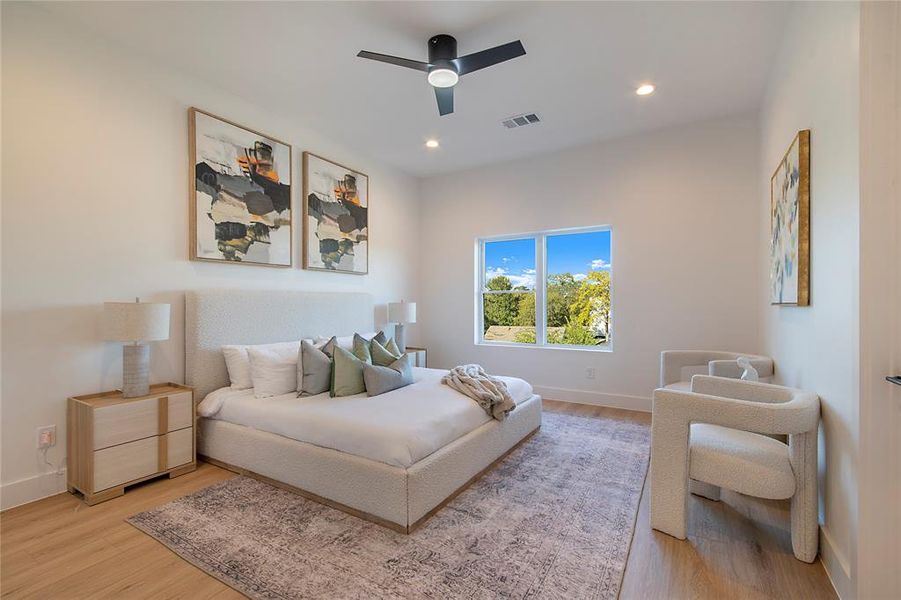 Bedroom featuring light wood finished floors, recessed lighting, and ceiling fan Bedroom featuring light wood finished floors, recessed lighting, and ceiling fan