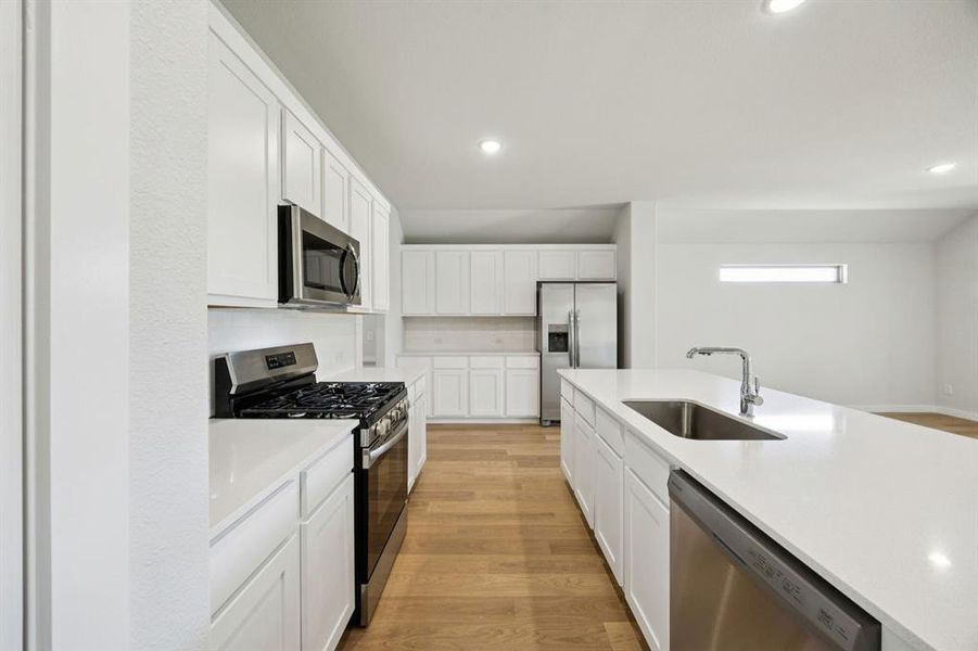 Kitchen in the Heisman home plan by Trophy Signature Homes – REPRESENTATIVE PHOTO