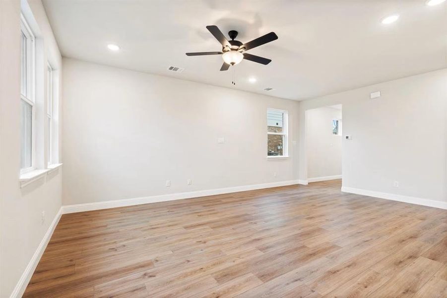 Unfurnished room featuring ceiling fan and light hardwood / wood-style flooring