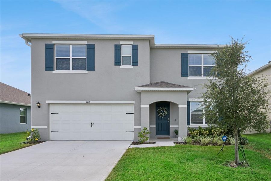 Front exterior of a new home in Concorde, Sanford, FL, highlighting curb appeal (Image 2).