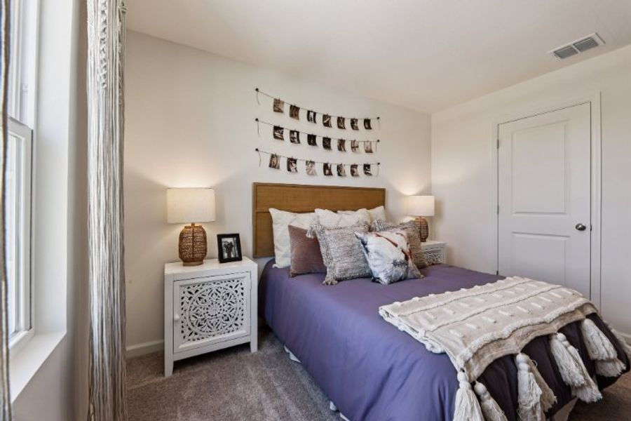 A bedroom with a bed and a lamp. A bedroom with a bed and a lamp.