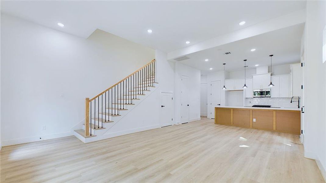 View of the 1st floor living areas. 11ft ceilings are accompanied by oversized windows that allow for a flowing and breathable entertaining space.