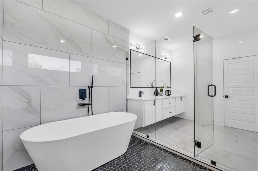 Bathroom with vanity, plus walk in shower, and tile walls