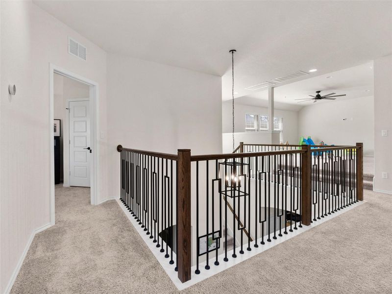 Corridor with carpet and a chandelier