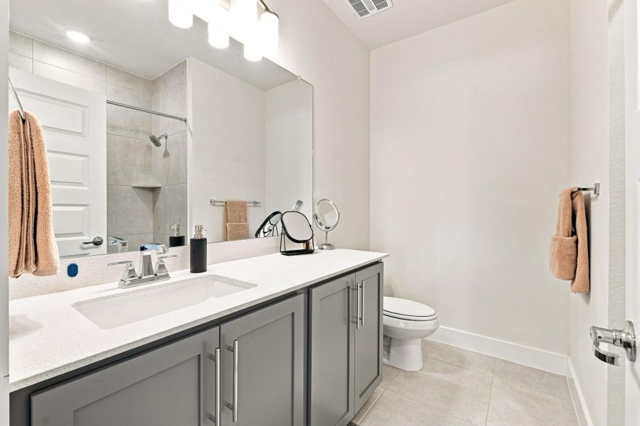 Upgraded full bath featuring North Sea cabinetry, Blanco Maple counter, rectangular undermount sink, and modern chrome fixtures. Upgraded full bath featuring North Sea cabinetry, Blanco Maple counter, rectangular undermount sink, and modern chrome fixtures.